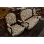 A French walnut salon suite comprising a two seater settee and a pair open arm chairs, floral