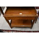 An Art Deco style oak two tier work table with full width frieze drawer