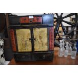 A Chinese painted wood cabinet with one drawer above and two drawers below cupboard doors