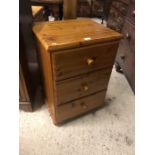 A pine three drawer chest