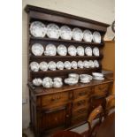 A good quality 17th century style oak dresser, the three shelf plate rack with a dentil moulded