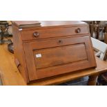 An Ercol refinished elm table top desk fitted with a single drawer over a sloped panel enclosing a