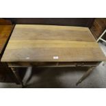 A bleached mahogany hall table with two frieze drawers, on turned and fluted supports with castors