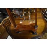 An old Victorian style cross-banded mahogany d-end twin pedestal dining table on brass caps and