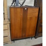 A 1960/70's White & Newton teak compactum wardrobe with two cupboard doors and two drawers raised on