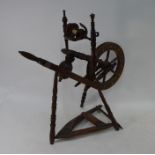 An antique inlaid cottage spinning wheel