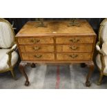 A Queen Anne style walnut chest of six drawers with brass handles raised on carved cabriole supports