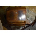 A 1950s Queen Anne style mahogany bureau