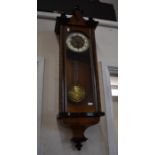 A figured walnut cased Vienna style twin-train wall clock