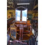 A mahogany serpentine top coffee table on slender cabriole supports with quartet of conforming