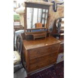 A mahogany dressing chest, the raised back with a large bevelled mirror and small drawer over