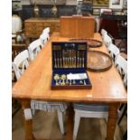 A large waxed pine rectangular dining table with moulded top raised on a plain frieze and turned