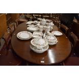 A Blanchards Georgian style extending dining table, the oval top with single central leaf on a