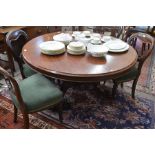 A Victorian mahogany dining table, the circular top raised on an octagonal baluster column and
