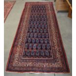 Persian Arak runner, the central reserve filled with a boteh design on a blue ground, within