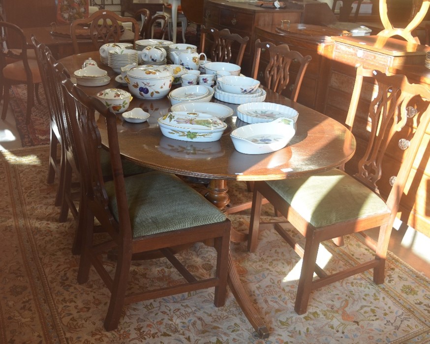 A 19th/20th century mahogany twin pedestal dining table, with single central leaf, raised on a