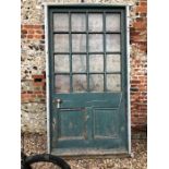 An antique architectural oversize sixteen pane door, within frame, ex Southern Railways