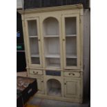A French cream painted distress-finish dresser with wire panelled doors and open shelves over