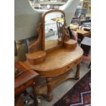 A late Victorian mahogany bowfront dressing table with arched mirror, two small drawers and single