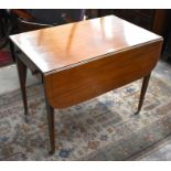 A Regency mahogany and ebony inlaid Pembroke table with drop leaf top, frieze drawer and opposing