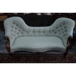 A Victorian serpentine mahogany framed double spoon back sofa