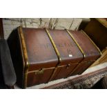 A large brown canvas wood bound travel trunk