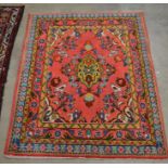 A Persian Tabriz small rug, the red ground decorated with birds and floral design within rosette