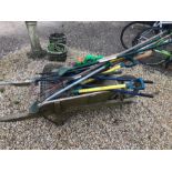 A weathered wooden wheelbarrow to/w a quantity of gardening tools including spades, shears etc. to/w