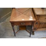 An Edwardian inlaid mahogany envelope card table with folding baise lined top and frieze drawer