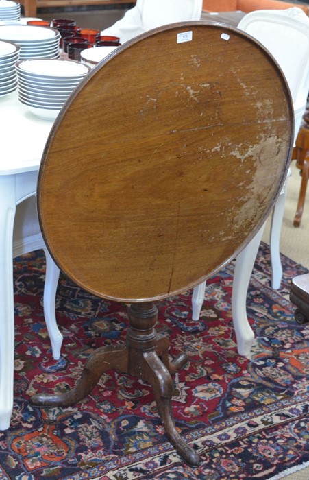 A 19th century mahogany tilt-top tripod table with turned column and triform supports