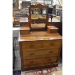 An Edwardian mahogany mirror back dressing chest with two short over two long drawers, raised on a