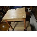 A vintage wooden school desk with hinged top