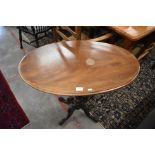 A Victorian mahogany oval occasional table on turned column and carved quadraform supports