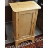 A small pine side cabinet with single panelled door enclosing two shelves