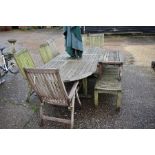 A weathered teak extending dining table with folding parasol, to/w a set of six Neptune Classics