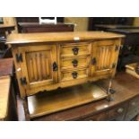 An Old Charm brand linen-fold design side cabinet with pot board to/with a matching cabinet and