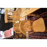 A set of six beech wheel back dining chairs to/w a Windsor style spindle back carver and a lyre back
