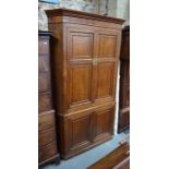 A Georgian oak corner cabinet in two parts