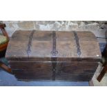 An antique iron bound oak seamans trunk, the domed top with over a tapering body