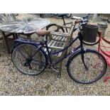A Bobbin Brownie traditional Dutch style ladies bike with front basket and pannier, purple frame [