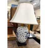 A modern Chinese blue and white table lamp decorated with dragons amidst clouds c/w shade