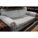 A Laura Ashley duck egg blue upholstered two seater sofa with scroll arms