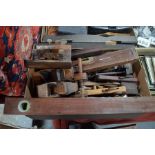 A quantity of vintage wooden woodworking planes and tools