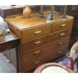 A teak chest of two short over three long drawers with moulded handles, raised on a plinth base