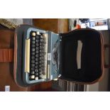 A vintage Imperial Good Companion portable typewriter and a vintage cased Jones sewing machine (2)