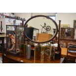 An Edwardian bevelled oval dressing table mirror, inlaid mahogany frame fitted with a shelf and