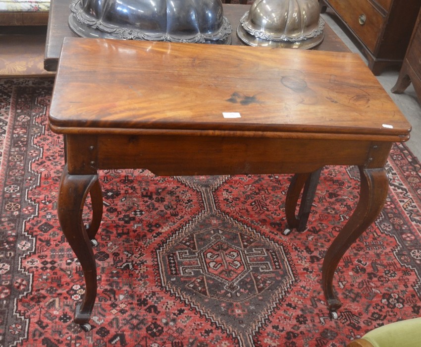 A 19th century mahogany card table with folding baise-lined top raised on cabriole supports with