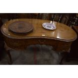 A Queen Anne style walnut kidney shaped desk with five drawers, raised on carved cabriole supports