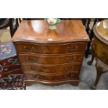 A Georgian style mahogany serpentine front chest of four long drawers, raised on shaped bracket feet