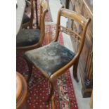 A set of seven matching Regency mahogany dining chairs with dark floral pad seats - six standard and